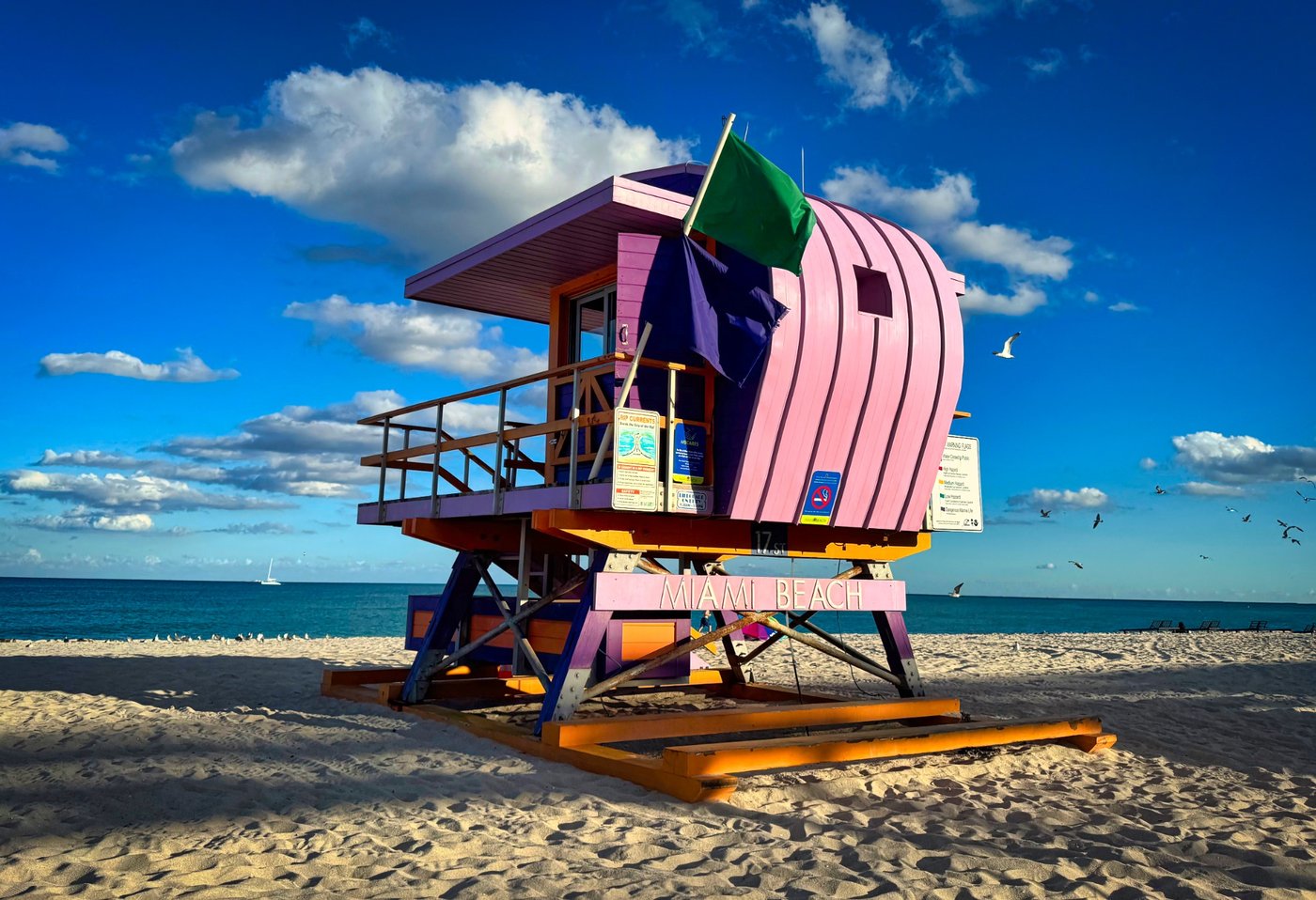 Pastel Paradise by the Sea Curved pink lifeguard tower on an orange platform beside the sea.