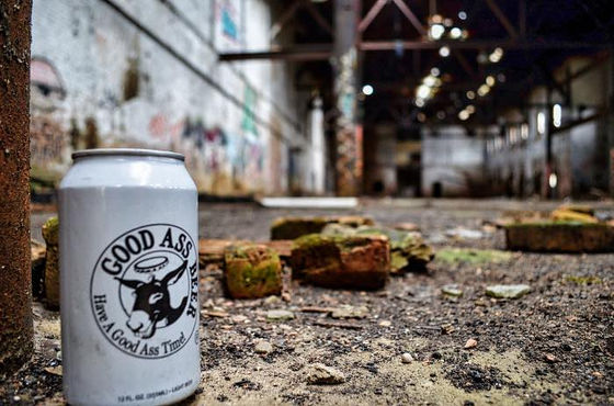 White drink can among loose bricks on an abandoned hall’s floor.