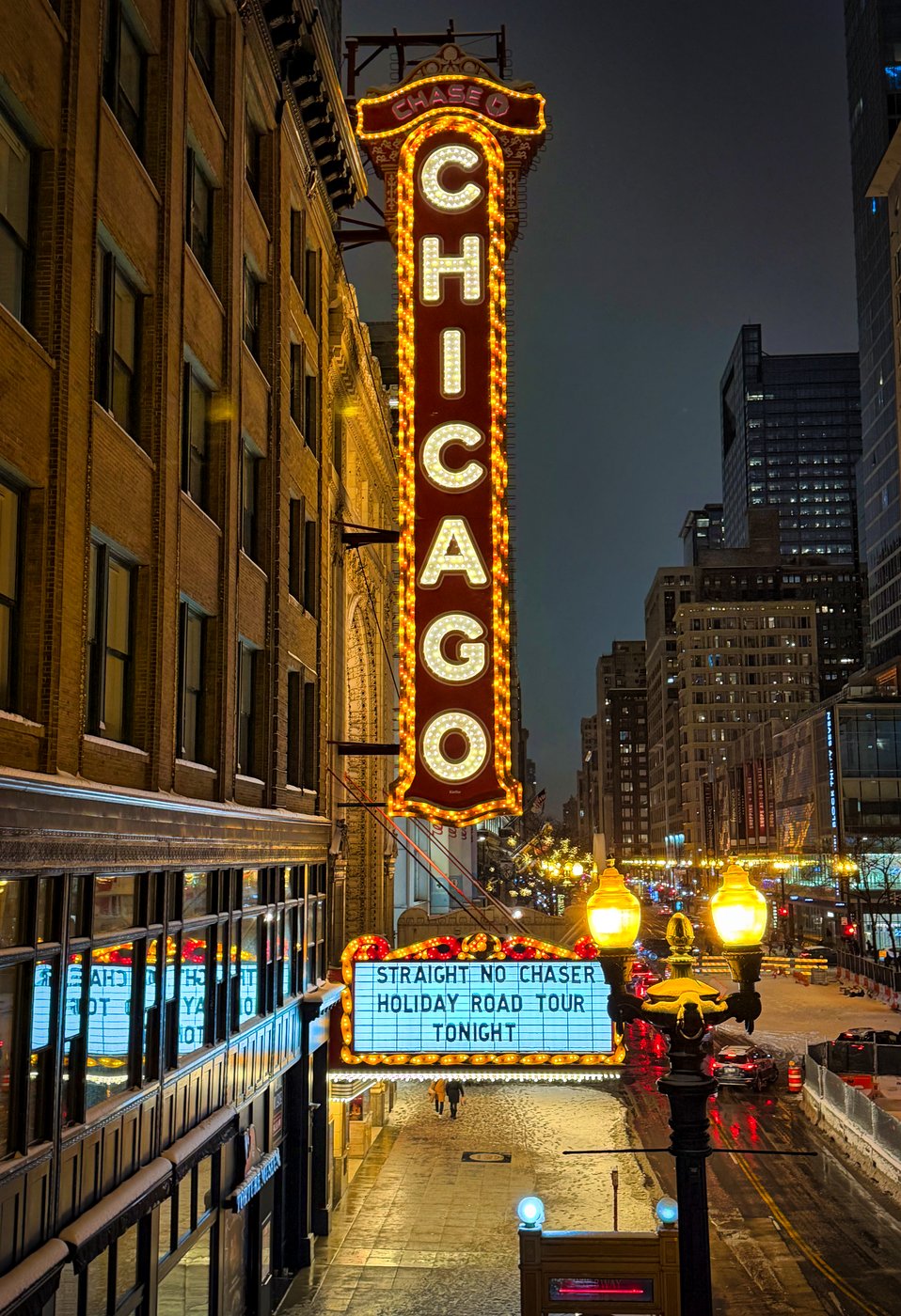 The Chicago Sign, Burning Bright Illuminated Chicago Theatre vertical sign and marquee above a nighttime street.