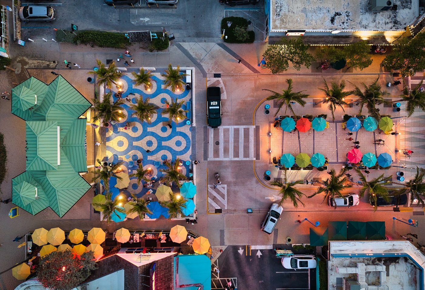 Patterns of Lauderdale-by-the-Sea Overhead view of a patterned plaza, colorful umbrellas, palms, and crosswalks.