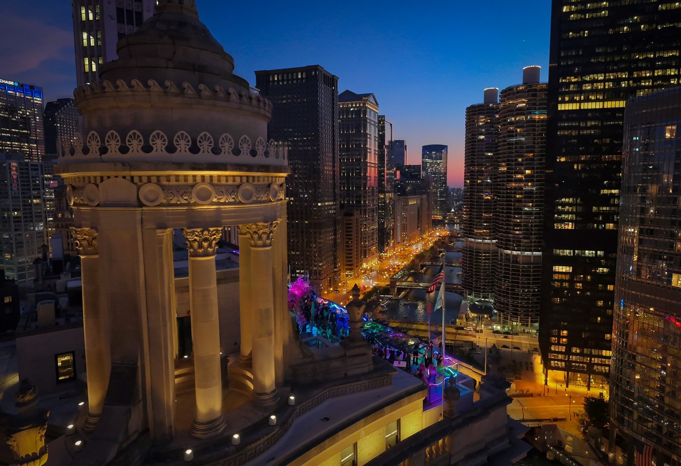 The City Beyond the Cupola Close elevated view of an ornate stone rotunda beside a Chicago street at dusk.
