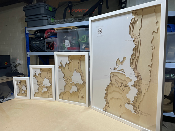 3D wooden maps of varying sizes on a table