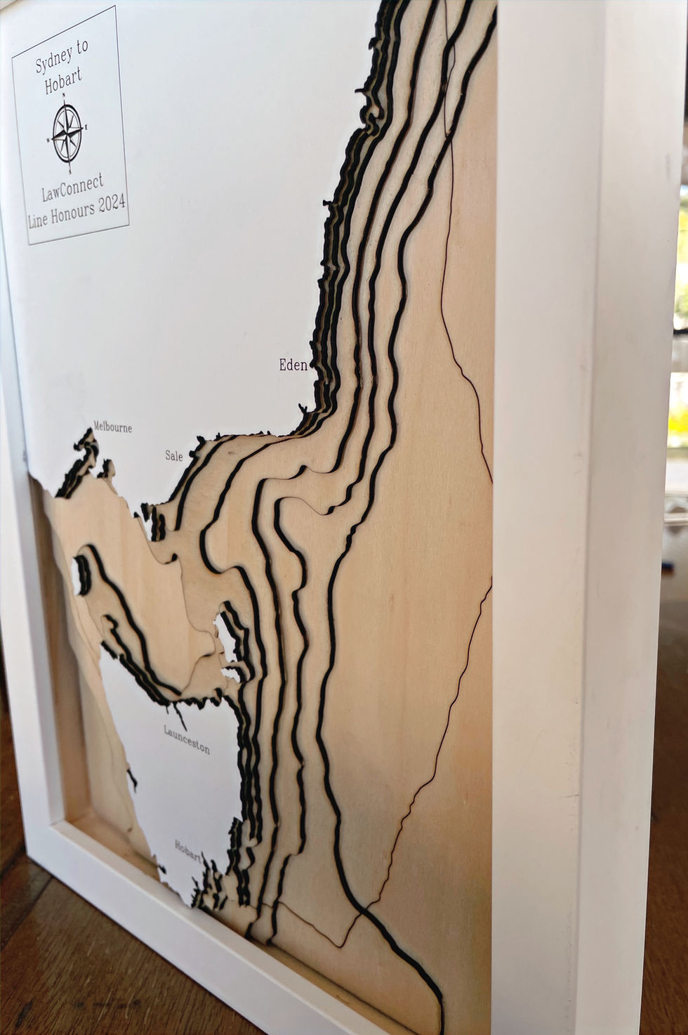 Closeup of 3D wooden topographic and bathymetric map of the 2024 Sydney to Hobart yacht race showing the route of Law Connect