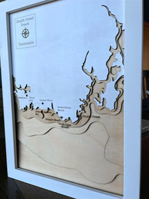 Angled view of a 3D wooden topographic and bathymetric map of the South Coast track in Tasmania