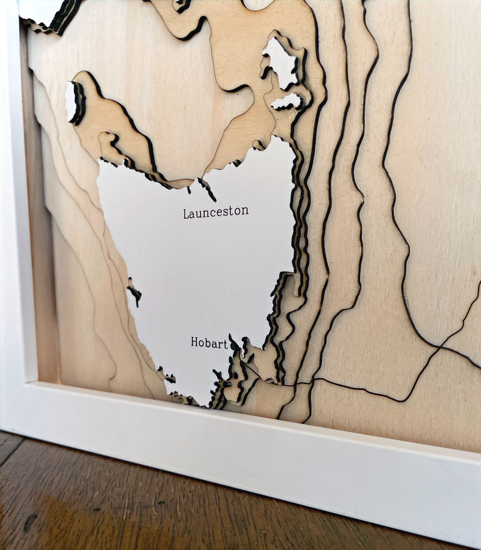 A 3D wooden topographic and bathymetric map of the 2024 Sydney to Hobart yacht race focusing on Tasmania