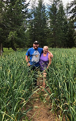 Mom and son in the mid season garlic feild