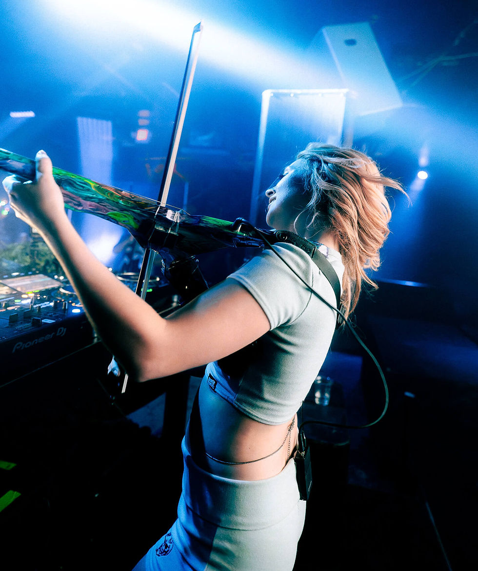 Performer playing electric violin under blue lights