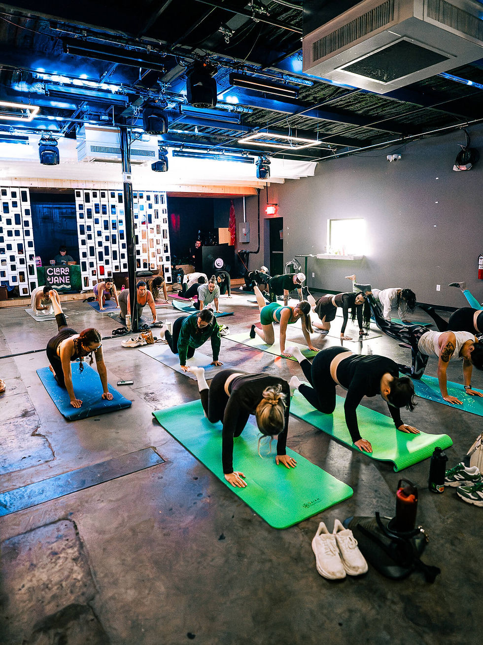 Group in fitness class doing planks on yoga mats