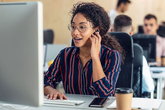 young-woman-working-at-computer-in-busy-office-2026-01-05-00-53-47-utc.jpg