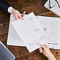 document-exchange-between-colleagues-on-wooden-des-2026-01-08-23-41-33-utc.jpg