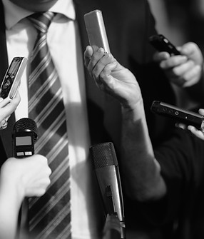 Journalists surrounding politician, asking questions. Retro style black and white processi
