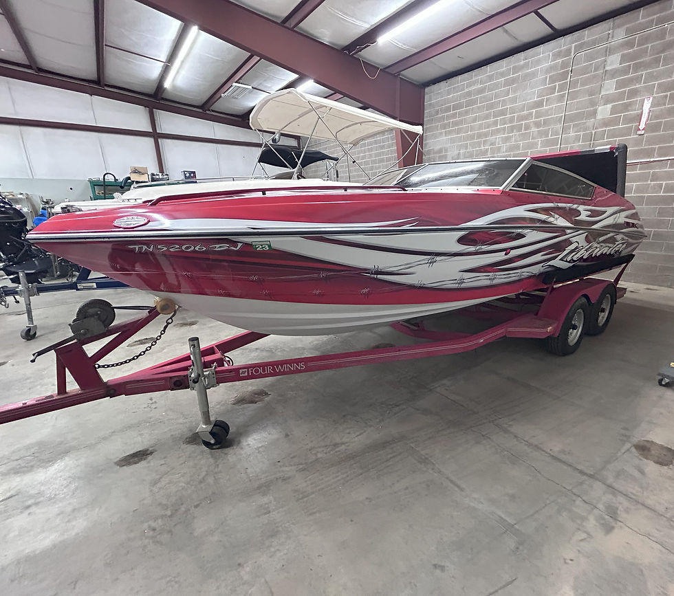989 24-foot Four Winns Liberator boat with custom red and white wrap.