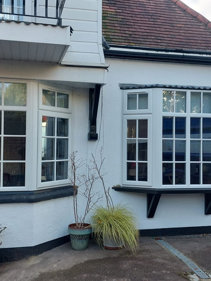 White uPVC bay windows with decorative glazing