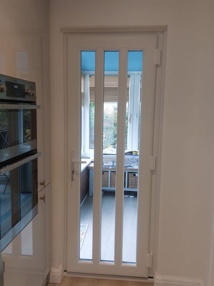 Interior view of white glazed doors leading into hallway