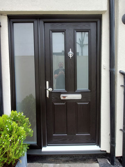 Black front door with chrome letterbox and knocker