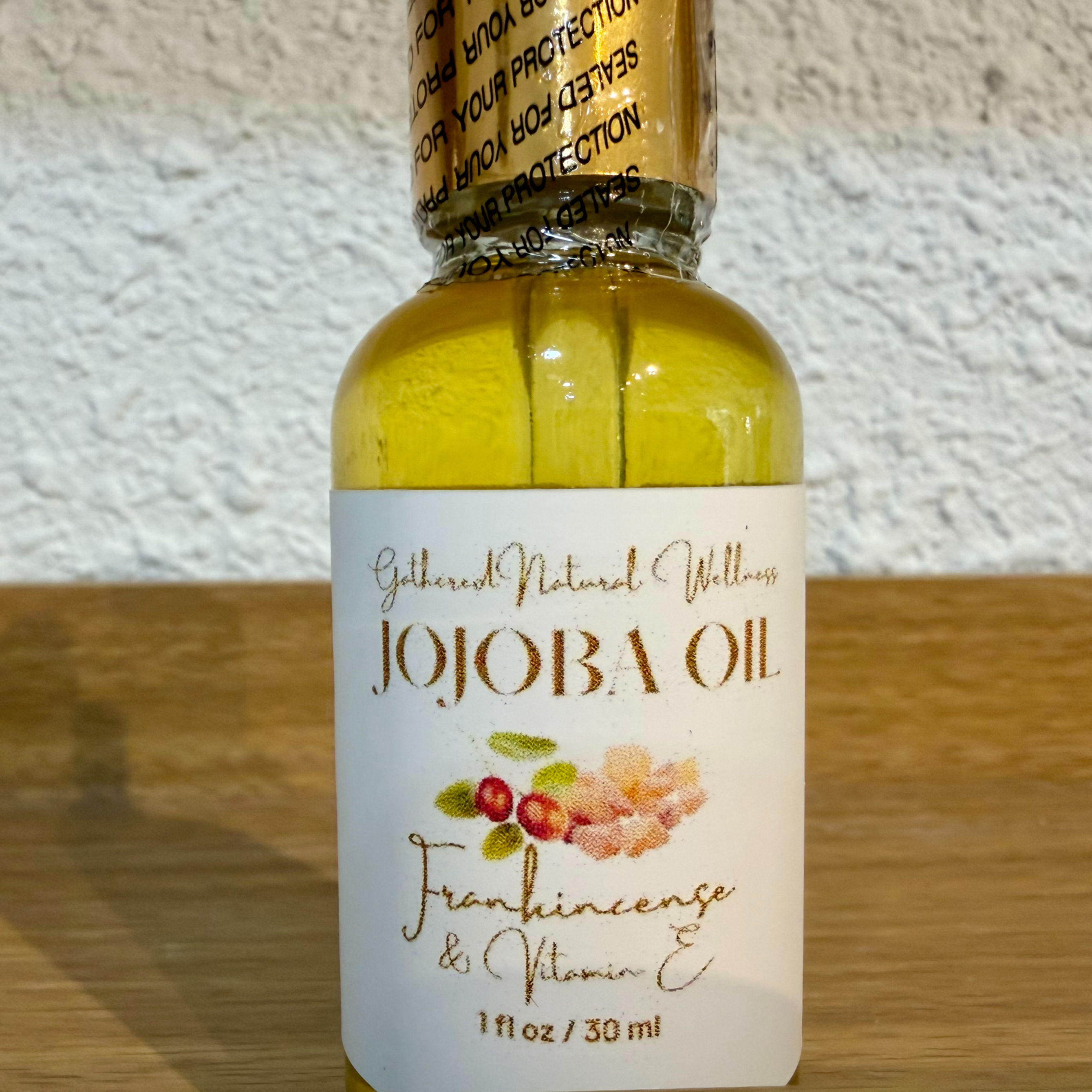 Jojoba Face Organic Serum glass bottle on display on wood shelf