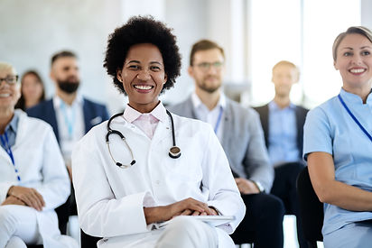 happy-black-female-doctor-attending-educational-event-convention-center.jpg