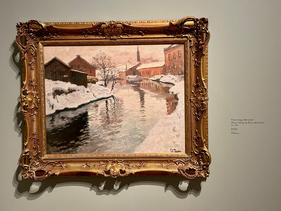 Ornate gold-framed winter river painting on a wall, snowy banks, reflected buildings, label Winter Along the River Akerseleven.