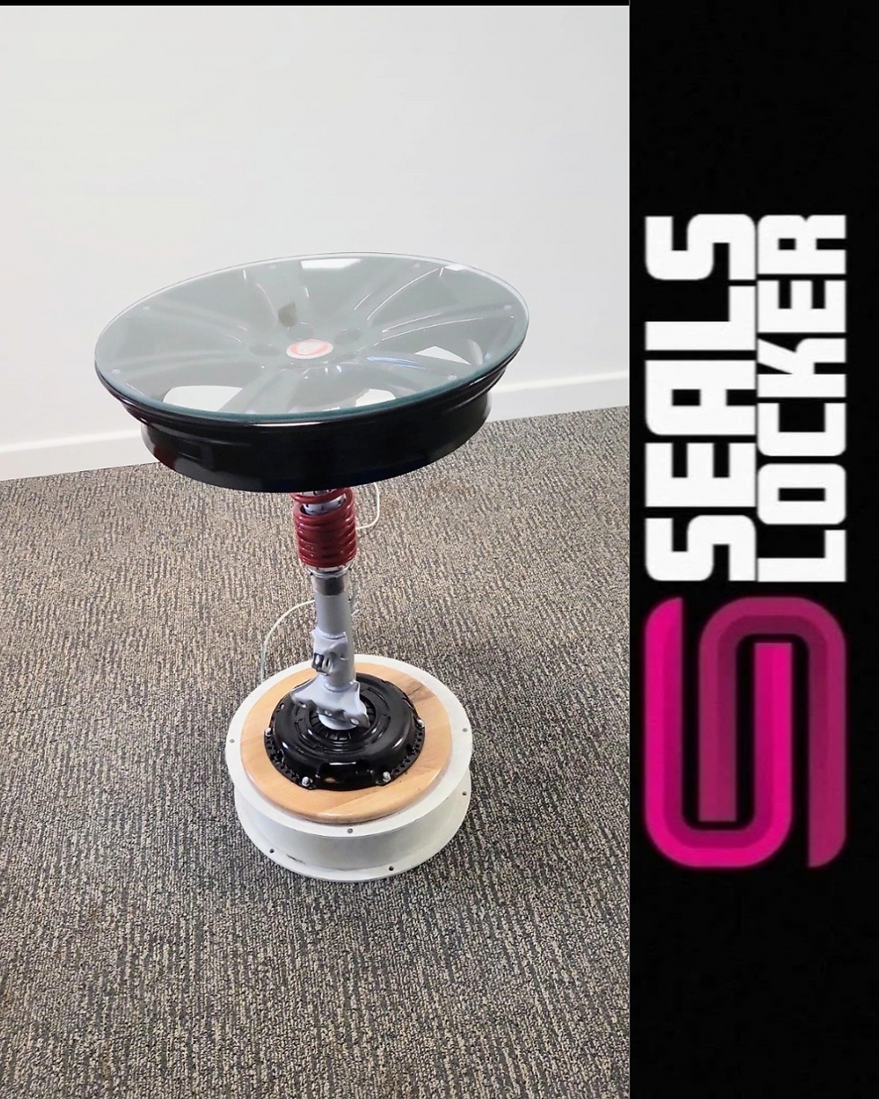 Thumbnail: Automotive Jaguar Alloy Wheel Mounted On A Coil Over On Oak Base Table