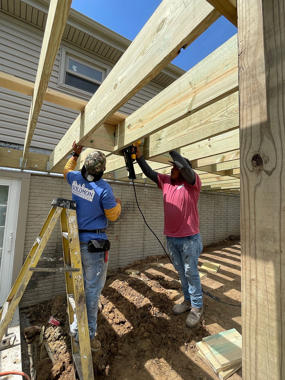 Eye-level view of a residential roof being repaired by a contractor