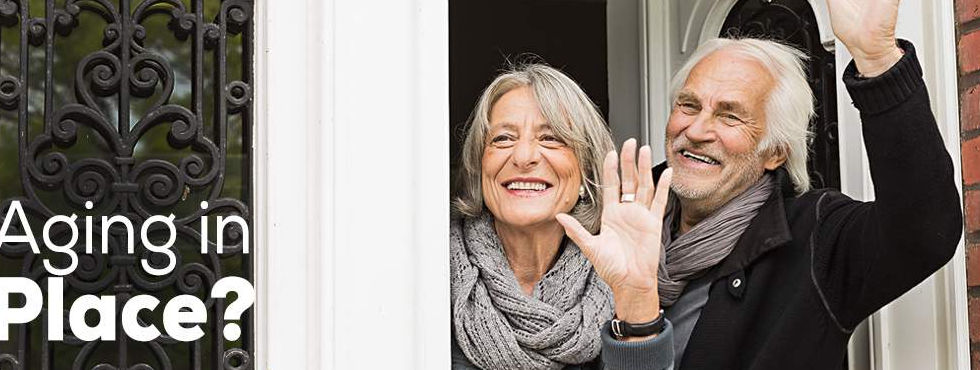 two senior citizens waving