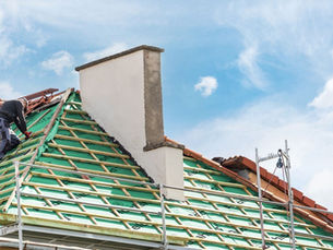 Roofers on a roof which is under construction