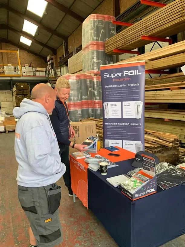 Two Roofers are looking at the Super Foil roofing display in Roofbase Leicester.