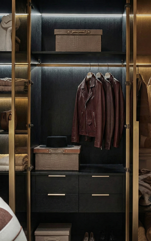 Modern dark wood walk-in wardrobe featuring custom open shelving, hanging rails, and soft-close drawers with integrated lighting by Omni Carpentree.