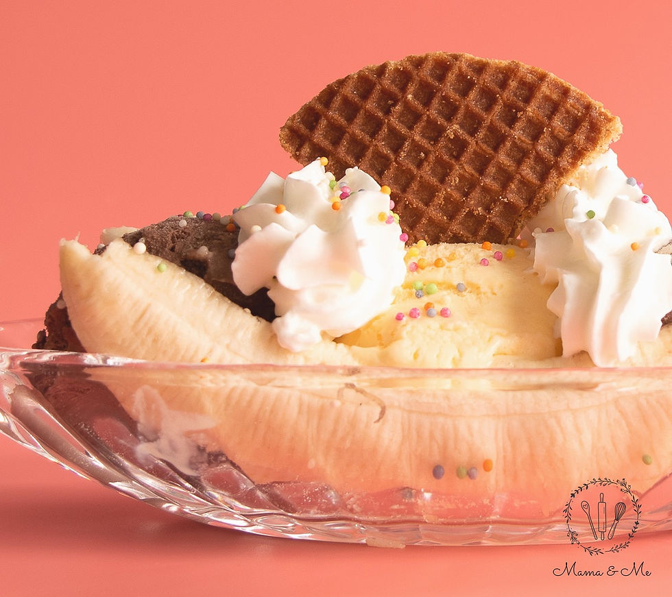 A banana split made with ice cream scoops, cream and a wafer