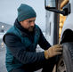 Business owner inspecting commercial vehicle tire