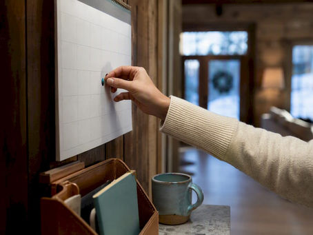 Hand marking an insurance renewal calendar