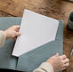 Hands placing insurance binder in folder