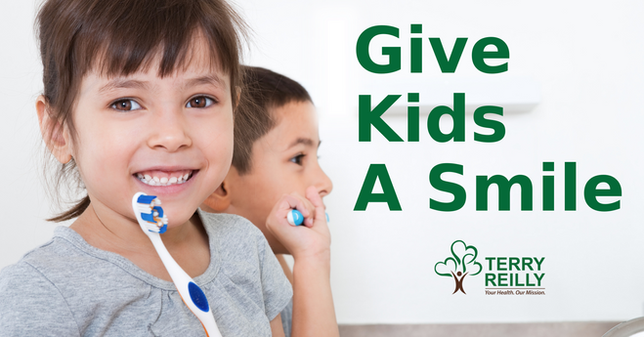 Two children brushing their teeth promoting Give Kids a Smile