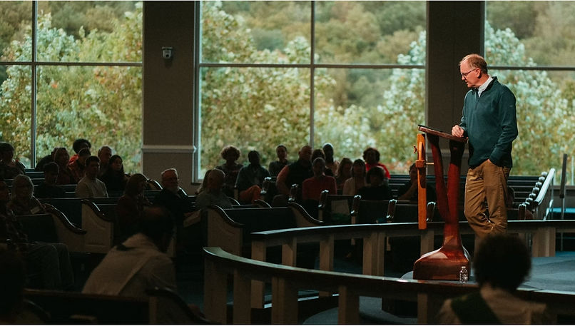 A group of young adults outside smiling for the camera.