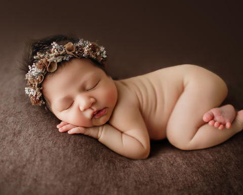 newborn baby sleeping with a flower crown