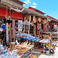 Colorful market stolls with little trunkets and art works.