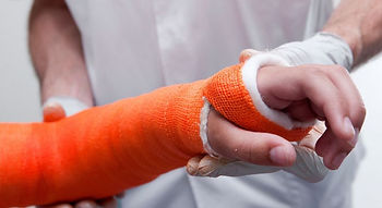 doctor holding a broken arm in an orange cast