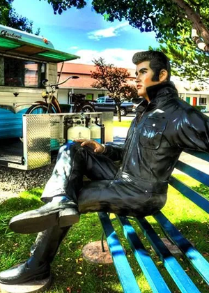 A statue of Elvis sitting on a bench at Retro Inn in Cortez, Colorado.