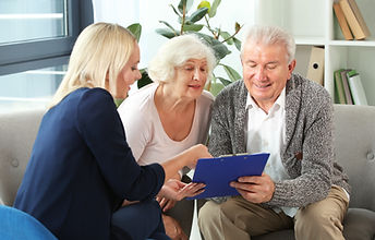 Elderly Couple Signing with Professional
