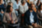 A group of people listening to a speaker during a seminar