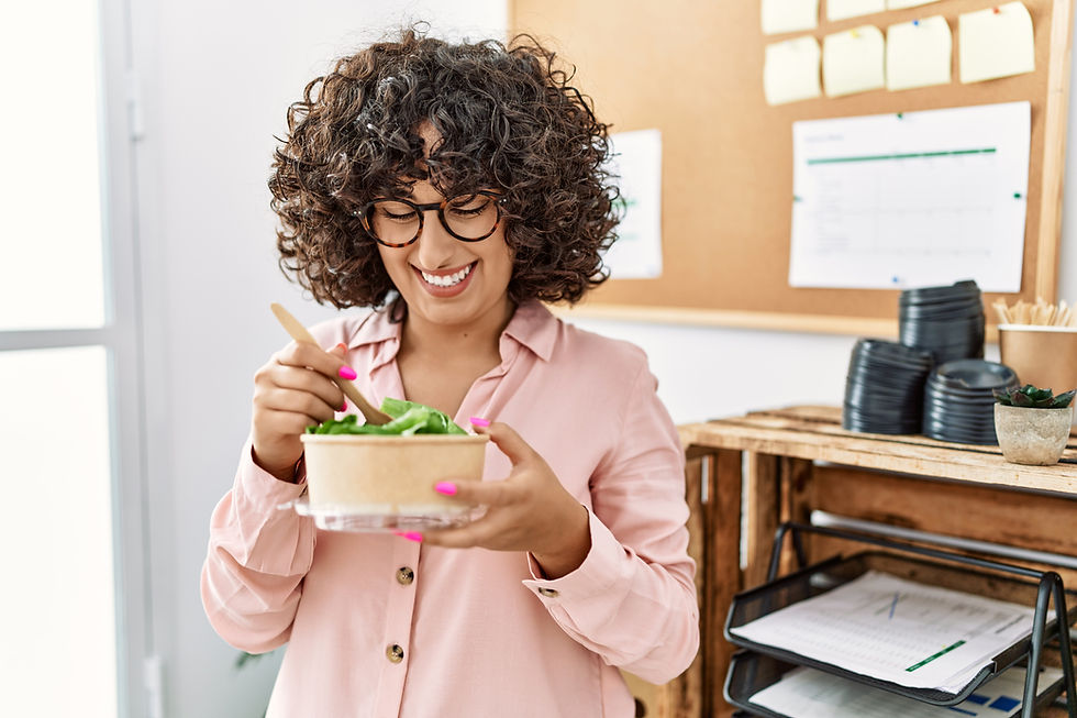 A woman in the office eating a salad