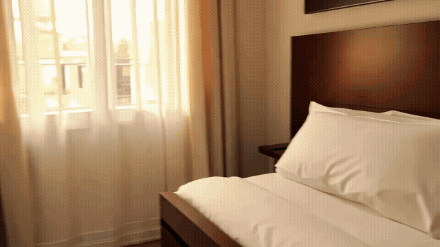 Gen-4_5 UGC-style handheld footage Interior Red Roof Inn-style midscale hotel roomClean, c