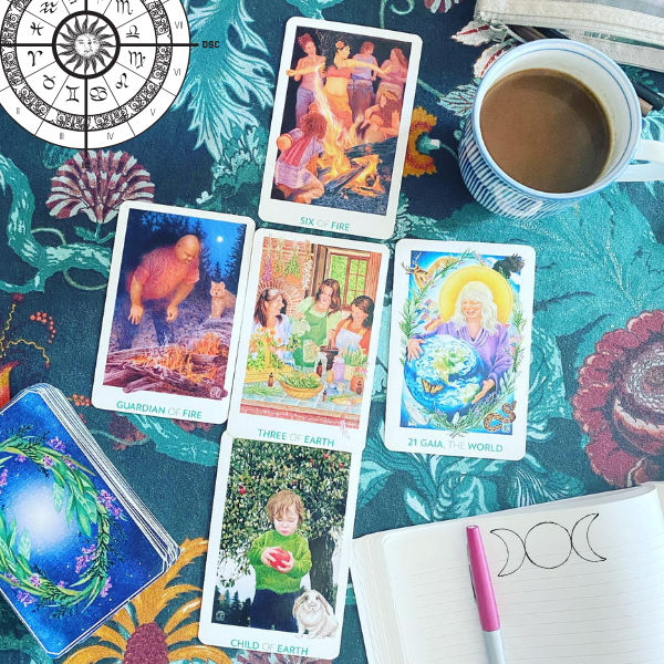 Astrology chart, Gaian tarot cards, in a new moon moonthly spread, moon phases and coffee, journal and pen to calm worry, anxiety and to cultivate clarity and direction.