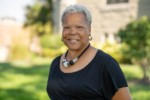 Smiling woman, short grey hair wearing black top and necklace, Hardon Education.