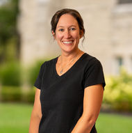 Smiling woman in black shirt poses outside with background ABOUT Hardon Education