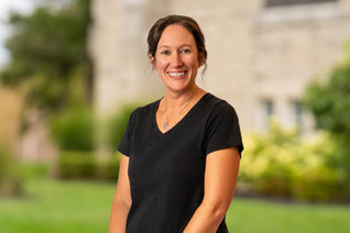 Smiling woman in black shirt poses outside with background ABOUT Hardon Education