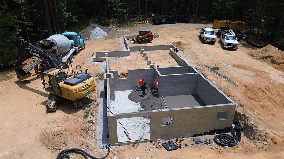 Crew Pouring Concrete Floor in House Foundation
