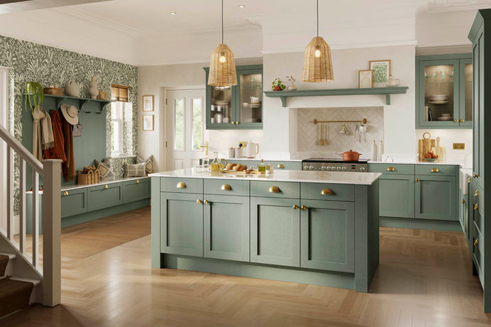 A soft sage green kitchen featuring a large central island with seating, perfect for family gatherings and entertaining.