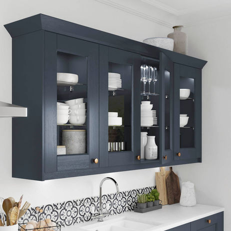 Elegant navy blue wall units with integrated lighting and glass shelving, perfectly showcasing fine glassware.