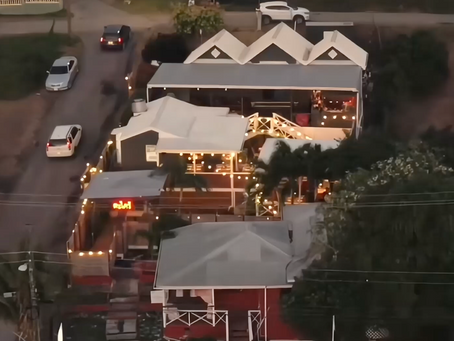 Drone view of Lemongrass Thai Lounge during sunset with string lights and evening ambiance